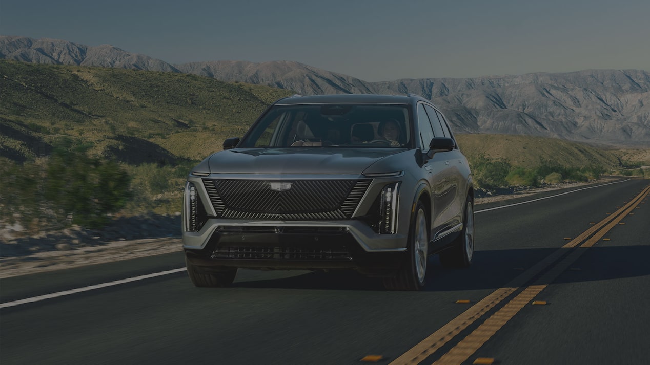 The 2027 Cadillac VISTIQ 3-row Electric SUV Driving Down a Road in the Mountains