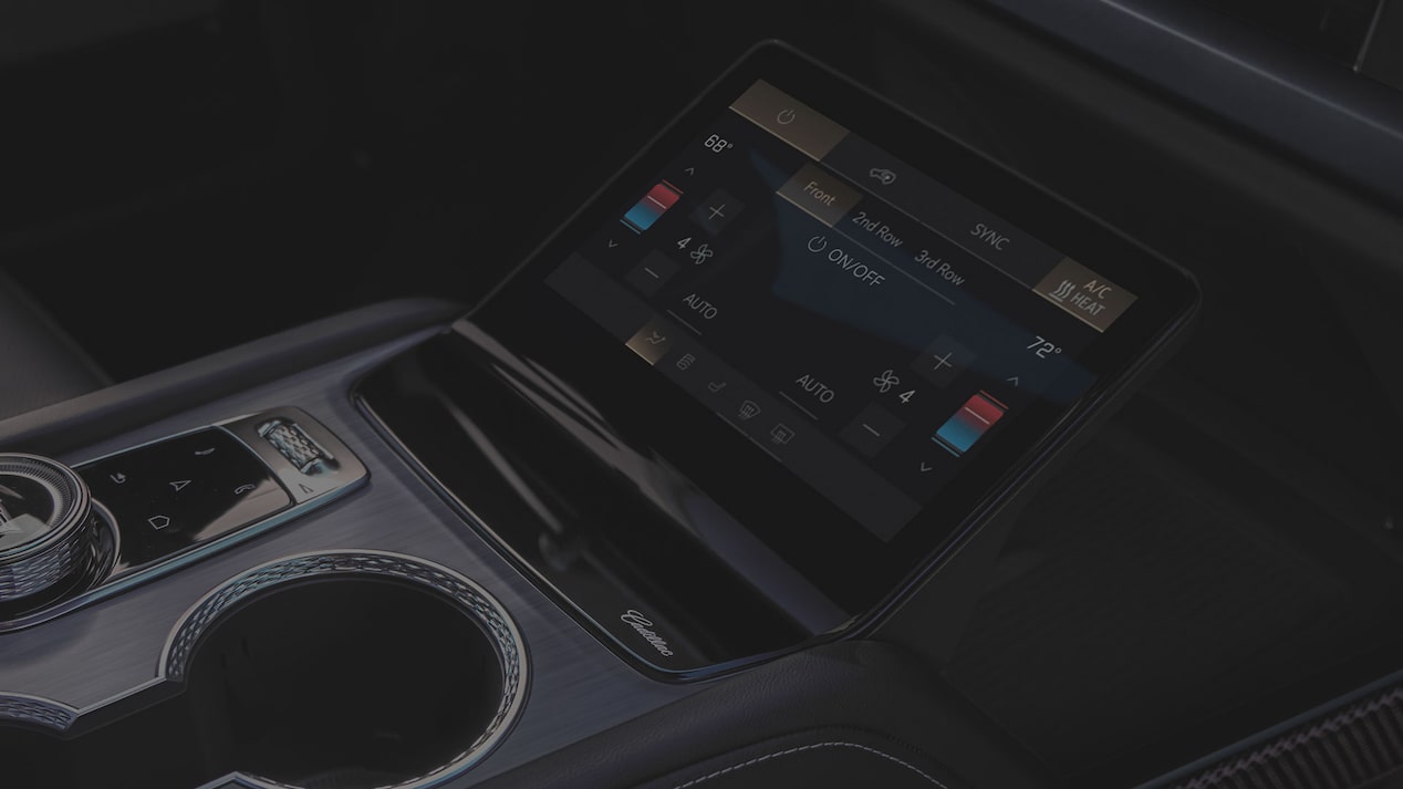 Close-up of the 2027 Cadillac VISTIQ Middle Console Including the Cup Holders, Gear Knob and Climate Control Screen