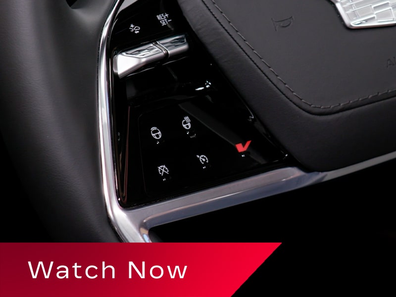 Close-up of the V Button on the 2027 Cadillac VISTIQ Steering Wheel