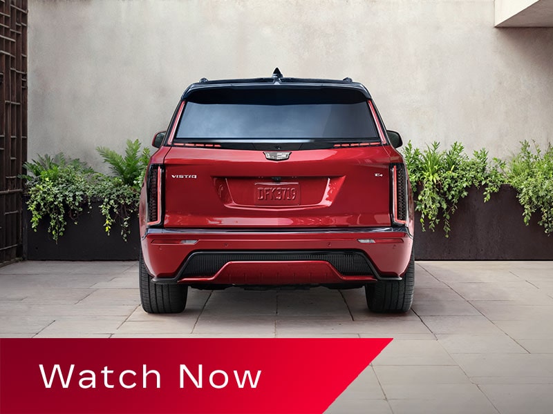 Rear View of a Red 2027 VISTIQ Parked on a Concrete Driveway