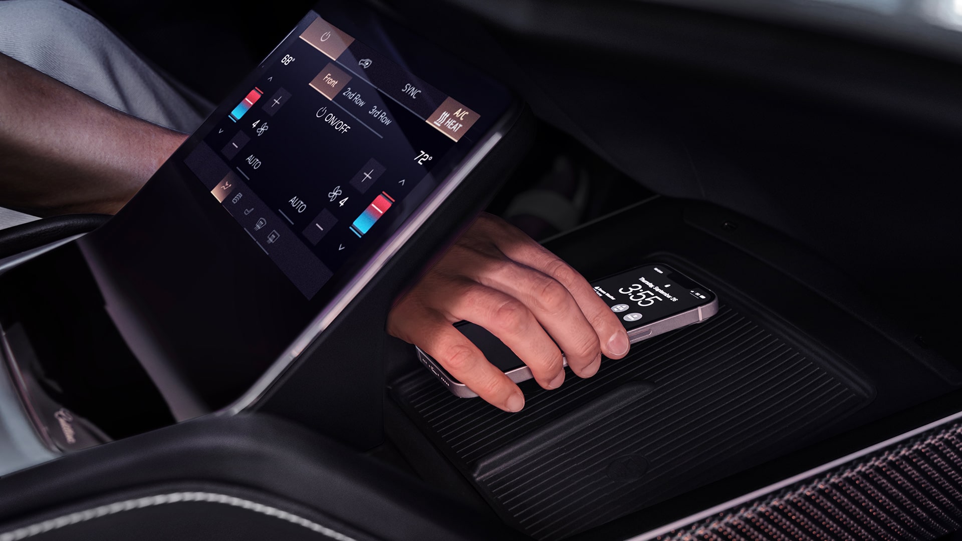 Someone Putting a Phone on the Charging Platform in the 2027 VISTIQ's Middle Console