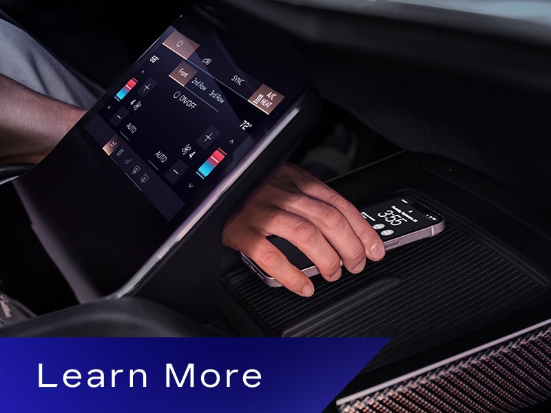 Someone Putting a Phone on the Charging Platform in the 2027 VISTIQ's Middle Console