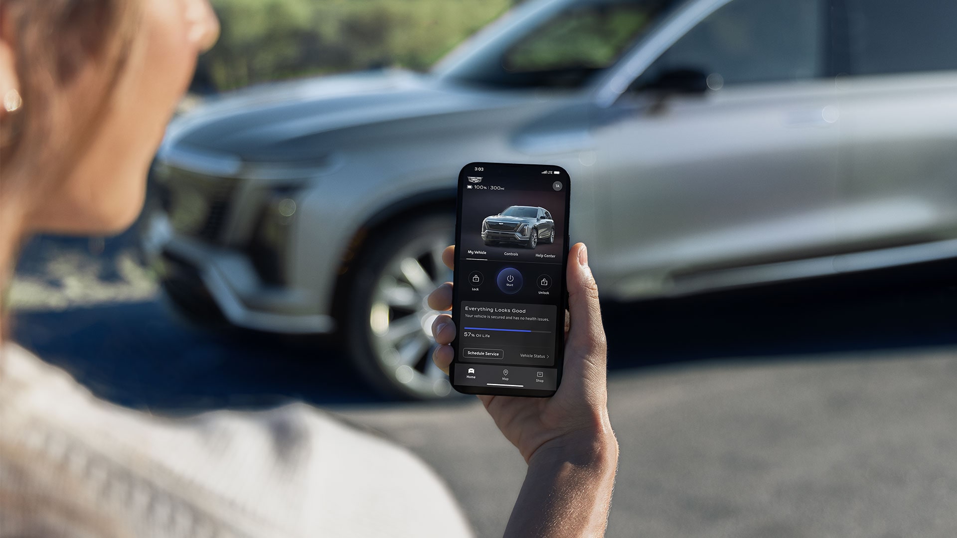 Close-up of a Woman Looking at Her VISTIQ Settings in the myCadillac Phone App