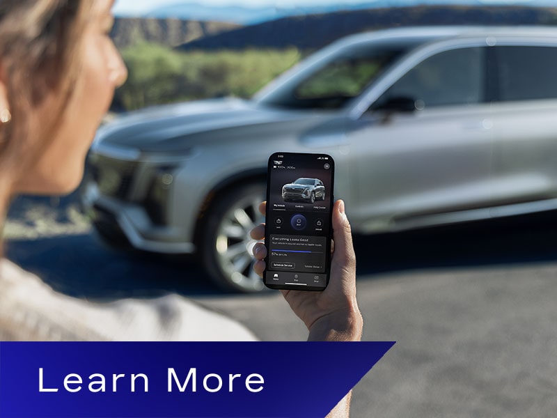 Close-up of a Woman Looking at Her VISTIQ Settings in the myCadillac Phone App