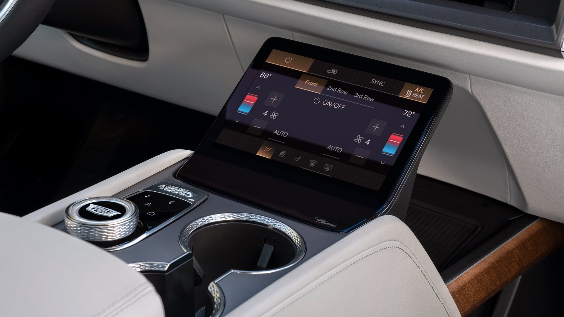 Close-up of a Cadillac VISTIQ's Center Console with Cup Holders and a Climate Control Display Screen