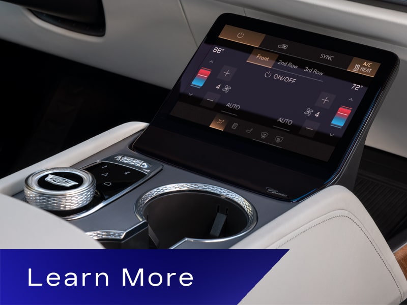 Close-up of a Cadillac VISTIQ's Center Console with Cup Holders and a Climate Control Display Screen