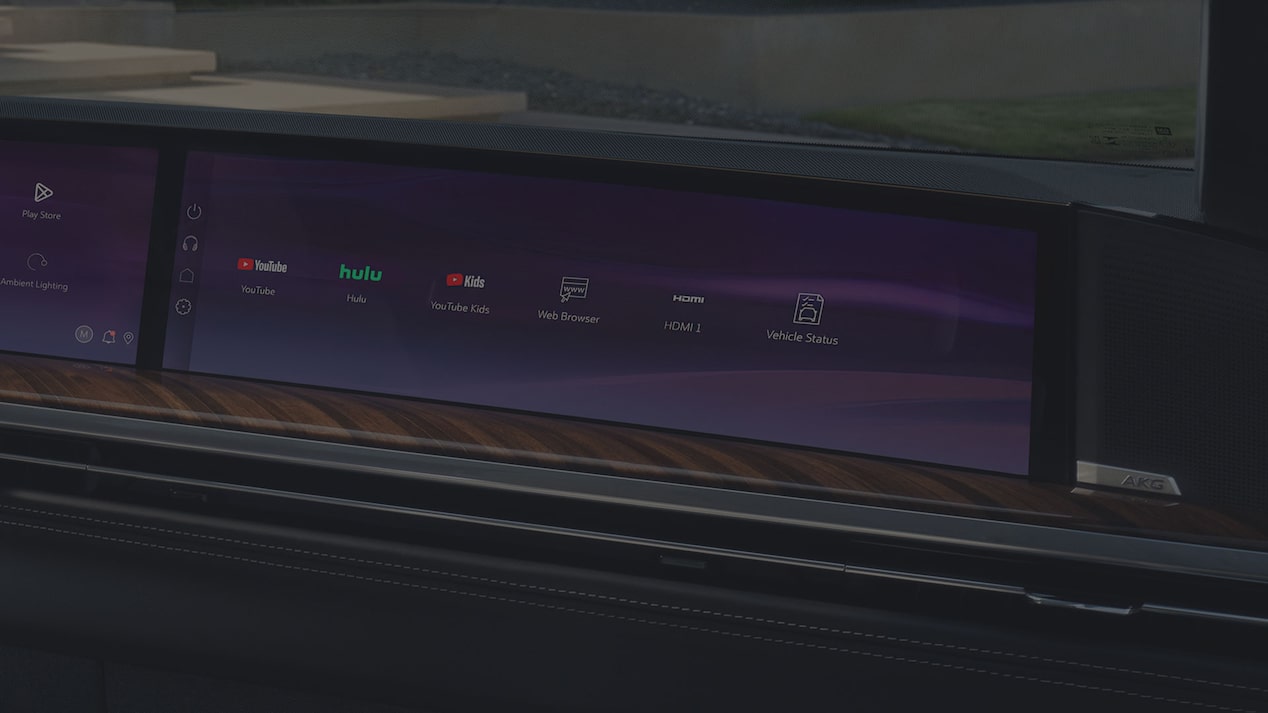 A 2027 Escalade Curved Display Screen Showing Integrated Entertainment Apps, Connectivity Features, and Vehicle Information