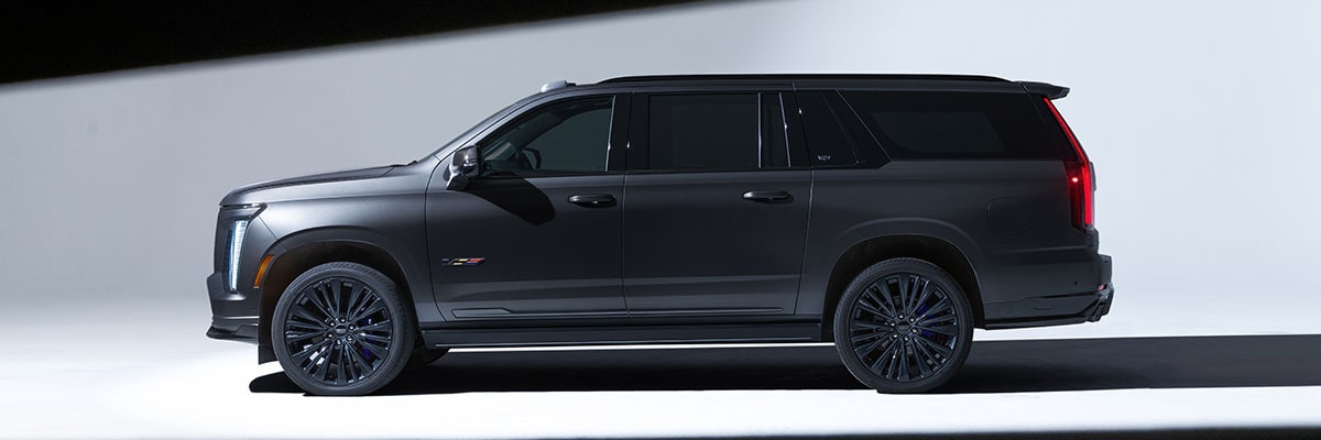 Profile View of a Black Cadillac Escalade-V Collector Series Parked in a White Showroom