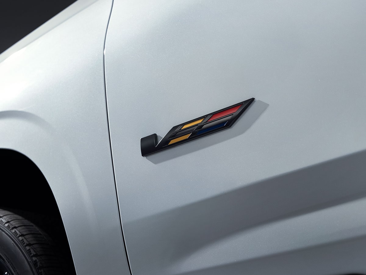 Close-up of the V-Series Logo on the Exterior of a White Cadillac Escalade-V