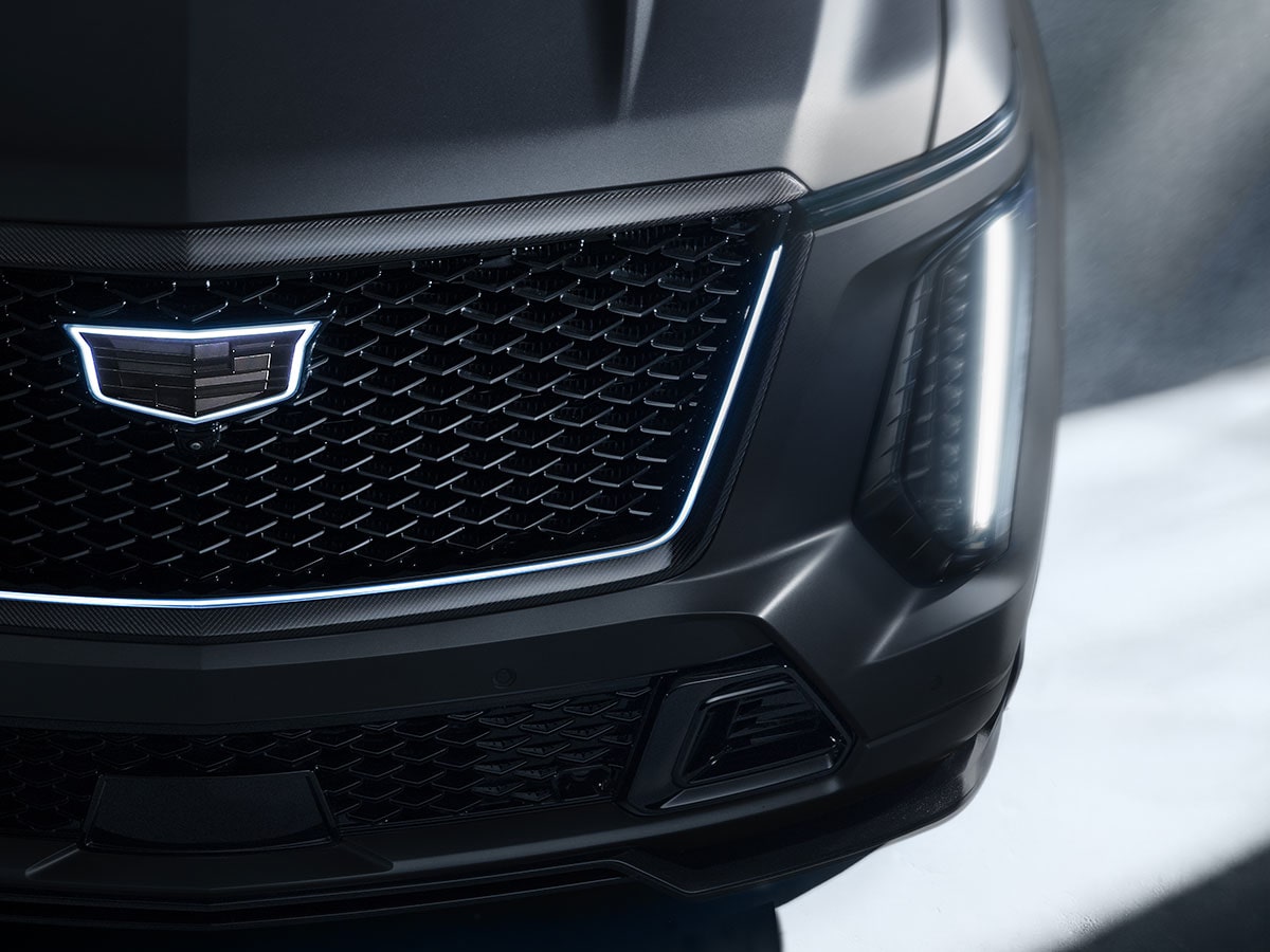 Close-Up of the Front Fascia of a Cadillac Escalade-V Collector Series Featuring an Illuminated Cadillac Crest on the Black Mesh Grille