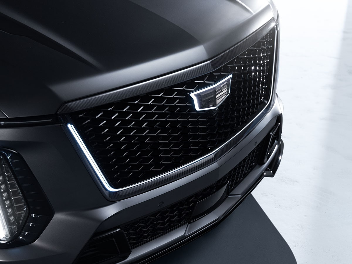 Close-Up of the Front Fascia of a Cadillac Escalade-V Collector Series Featuring an Illuminated Cadillac Crest on the Black Mesh Grille