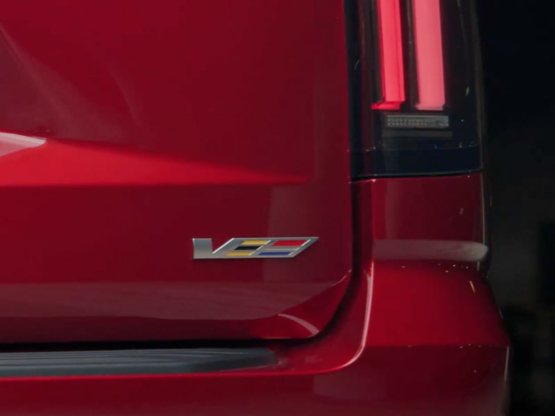 The V-Series Logo on the Rear end of a Red 2025 Escalade-V