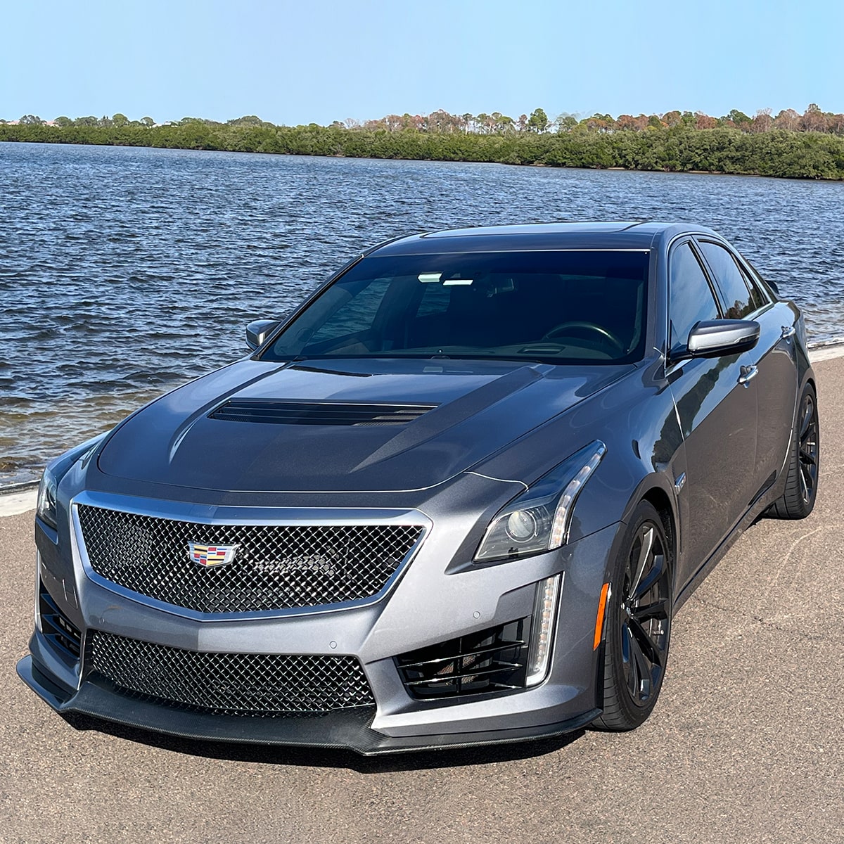 Cadillac CTS-V en Gris estacionado en frente de una calle, en frente de un lago