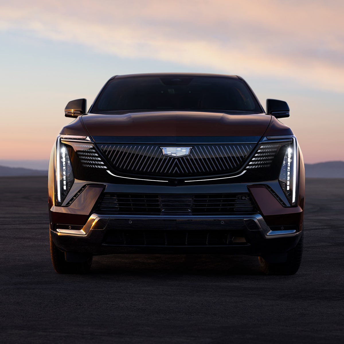 Front View of a Black Cadillac Vehicle Surrounded By a Red Hue