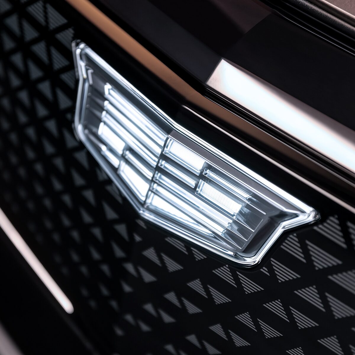 Close-up View of the Modern Crest on a Cadillac Grille in Blue Hue
