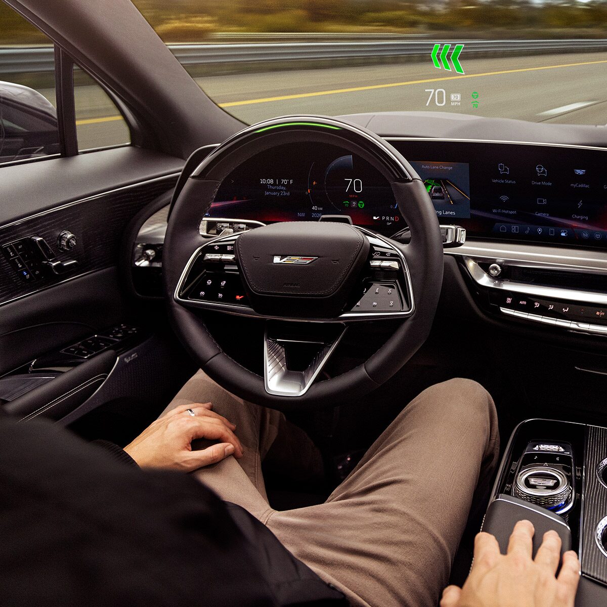 A Man Holding Sunglasses While Sitting in a Cadillac Vehicle Driver's Seat
