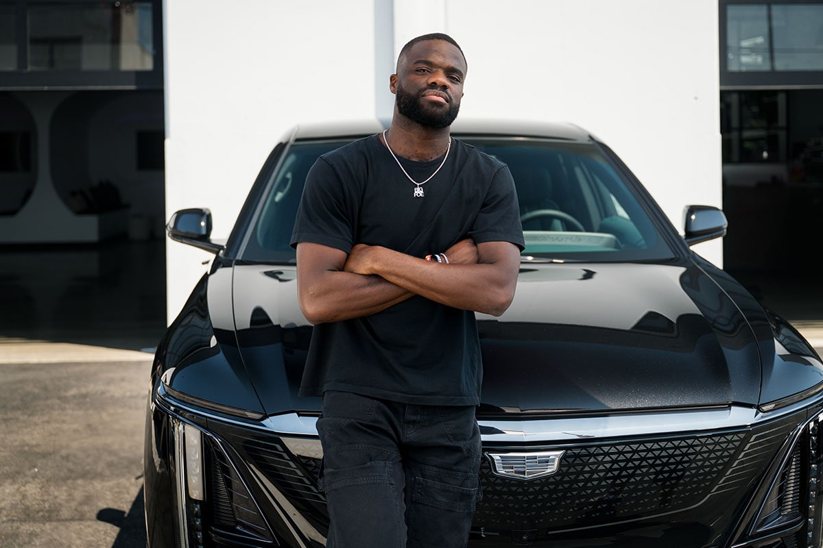 Tennis Player Frances Tiafoe Leaning on the Front of a Black Cadillac LYRIQ