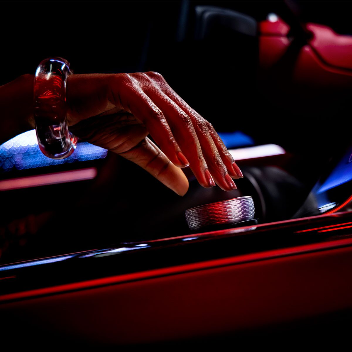 A Woman Using the Interior Shifting Dial in the Cadillac CELESTIQ