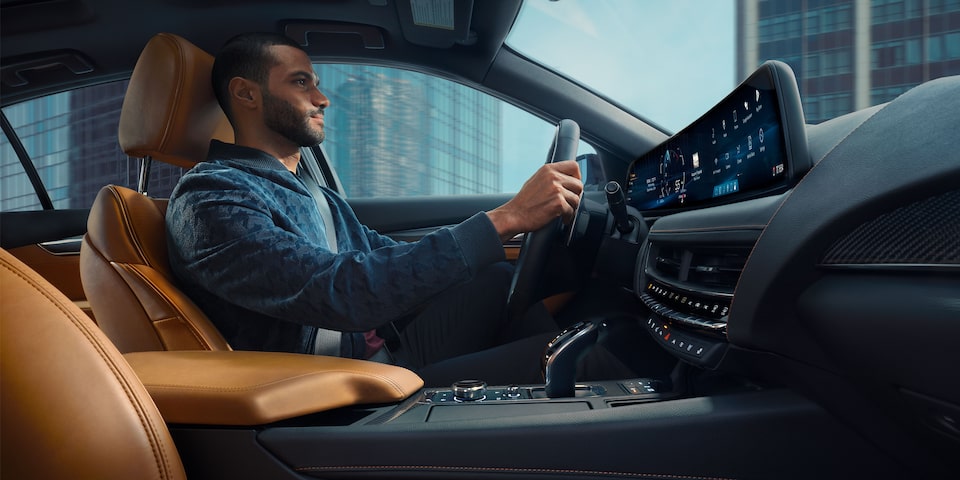 A Man Drives His LYRIQ with Both Hands on the Steering Wheel