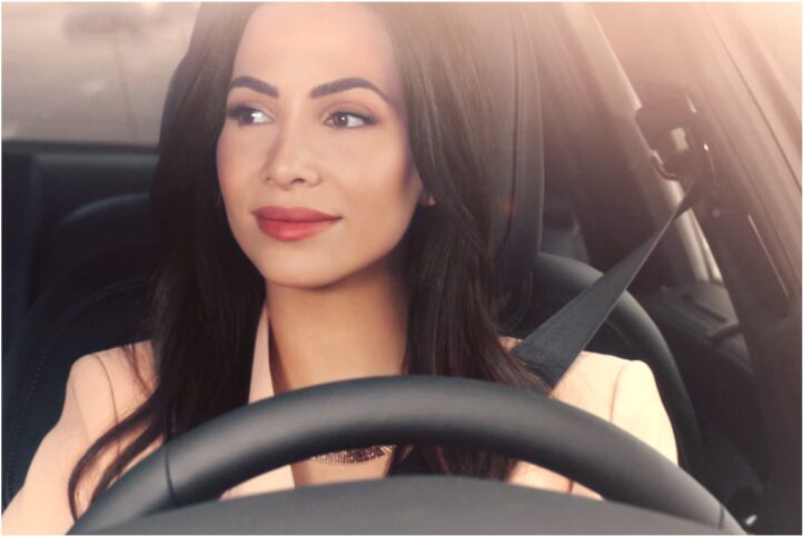 Cadillac: Woman sitting in driver seat using Super Cruise