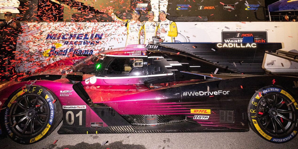 A Blurry Side View of the V-Series.R Racecar Speeding Down a Track