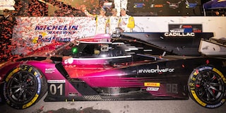 A Blurry Side View of the V-Series.R Racecar Speeding Down a Track