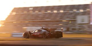 Front View of the V-Series.R Racecar Driving Down on a Track