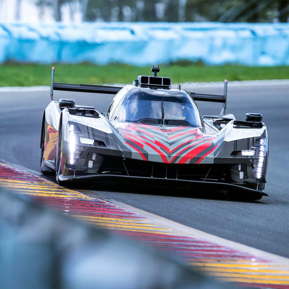 Cadillac Racing lmdh-V Race Car Ferociously Driving on Race Tracks Bend