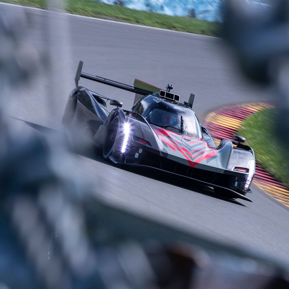 Cadillac Racing lmdh-v Race Car Driving with Head Lights on