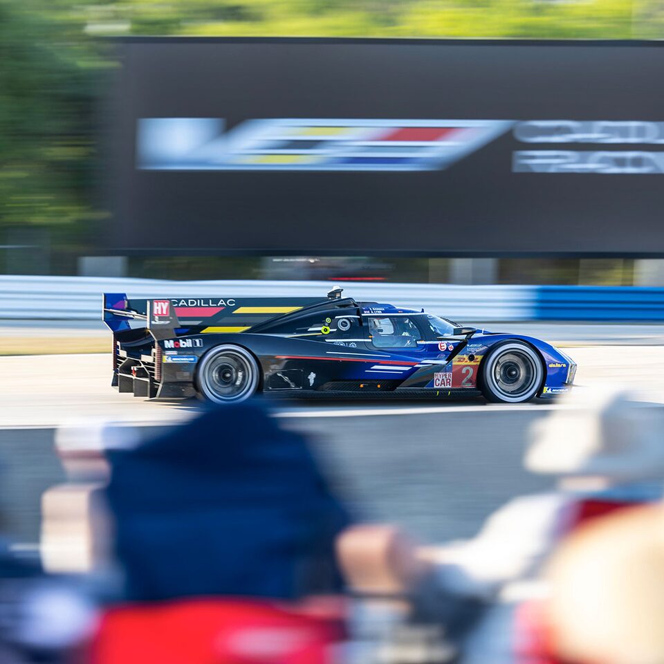 A Cadillac V-Series.R Prototype Race Car Speeds Past Spectators on the Track