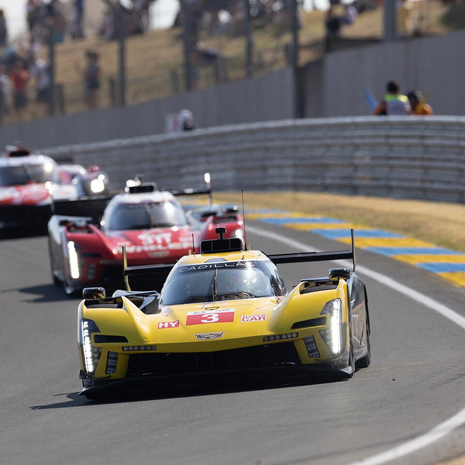 Cadillac V-Series.R Yellow Race Car Pulling Ahead Of The Pack