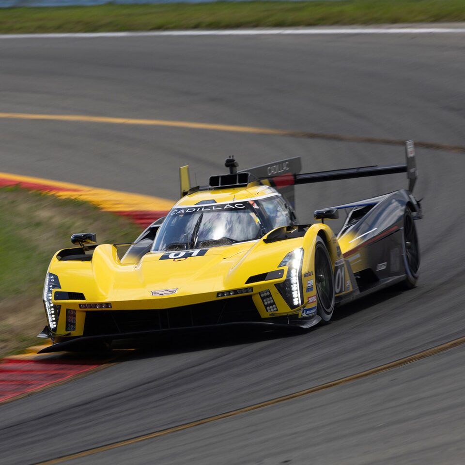 Yellow Cadillac V-Series.R Racing Around Bend On The Race Track