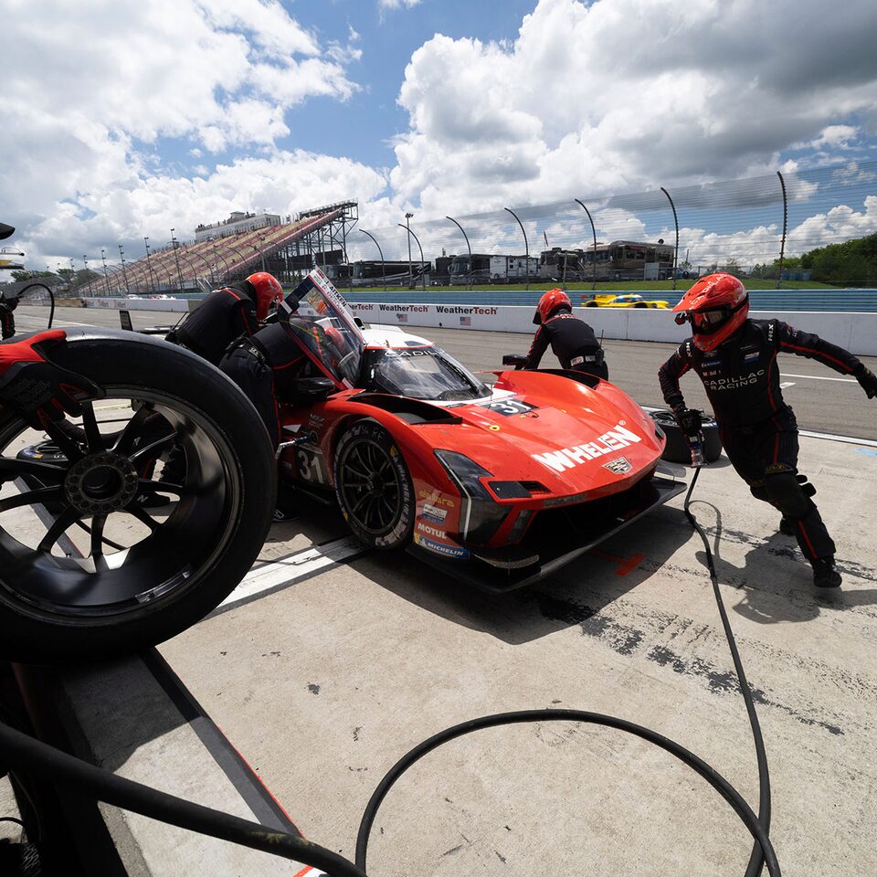 Cadillac Racing Pit Crew Quickly Changing The Tires On The Cadillac V-Series.R Race Car