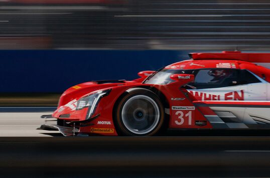 Cadillac Race Car Driving on Circuit Track