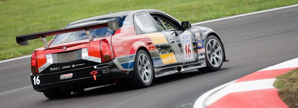 Cadillac Racing Sports Car Zipping By on Track