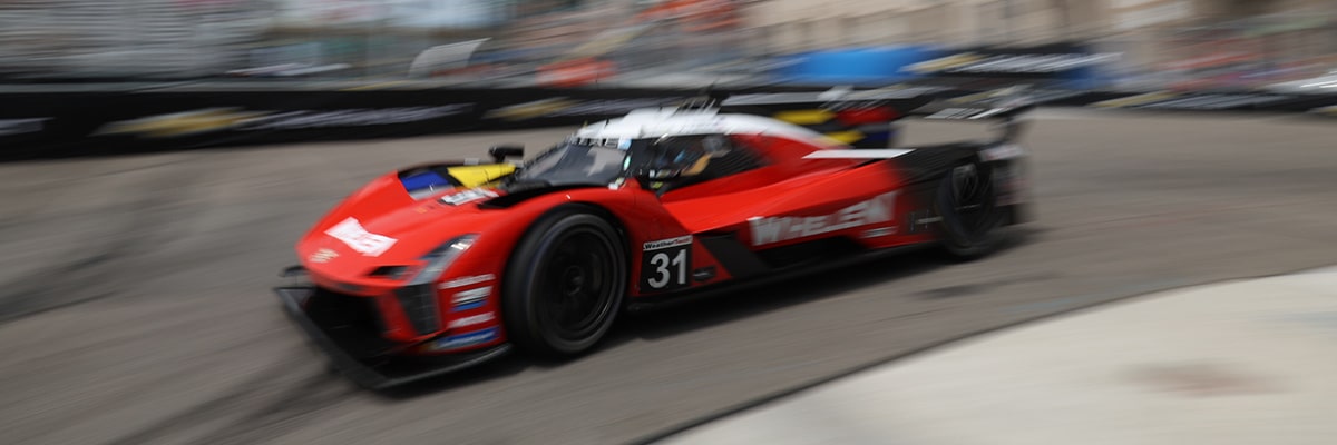 Side View of the Blue Cadillac V-Series.R Race Car Driving on the Track