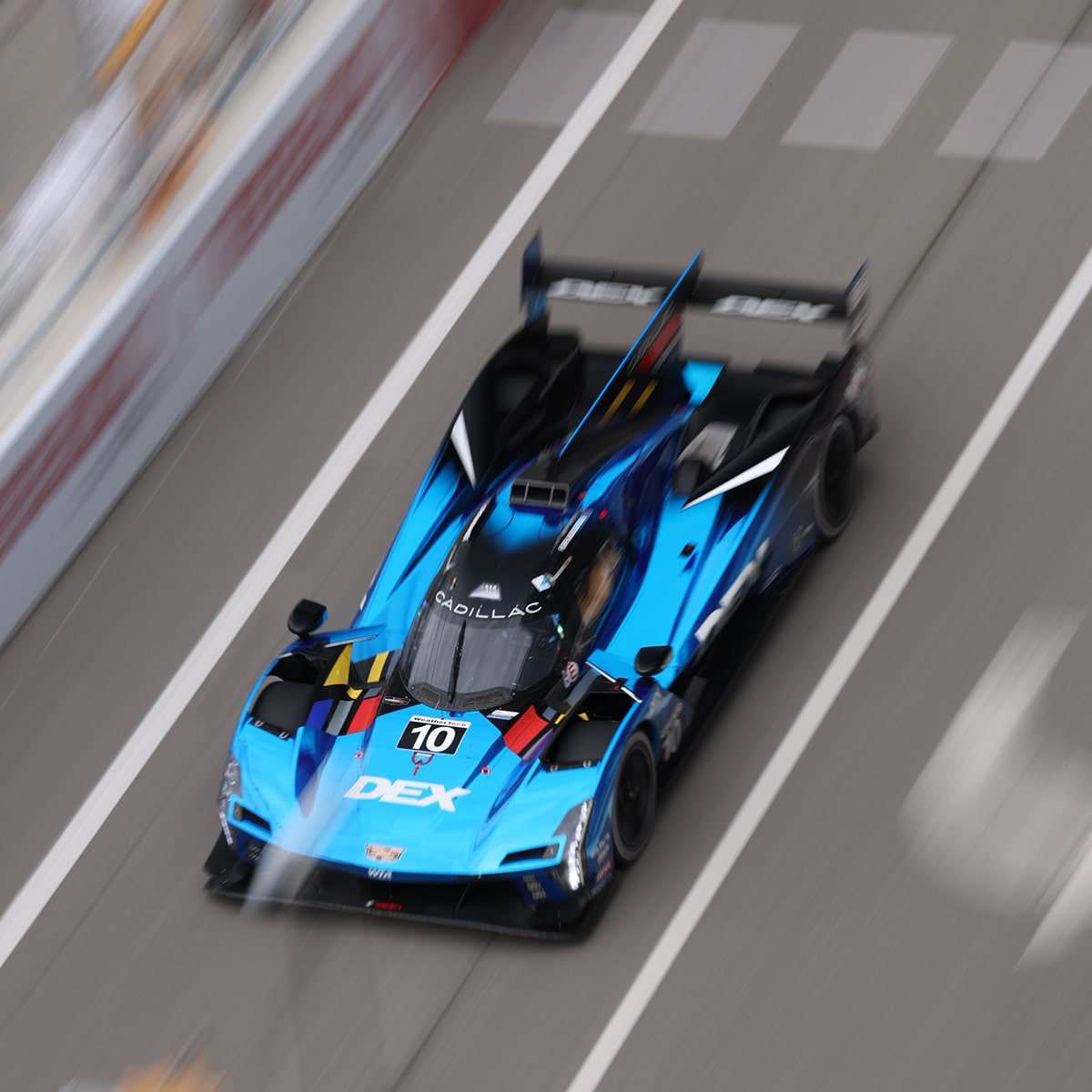 The Red Cadillac V-Series.R Race Car Speeding Around the Curve of the Race Track
