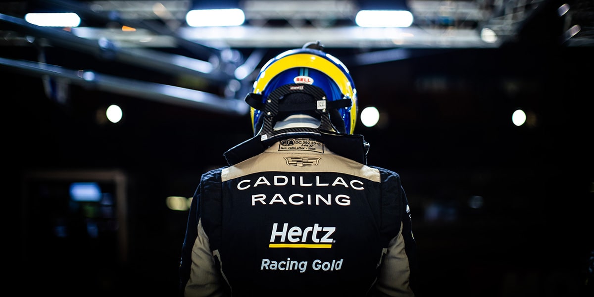 The Back of a Cadillac Race Car Driver with a Helmet On