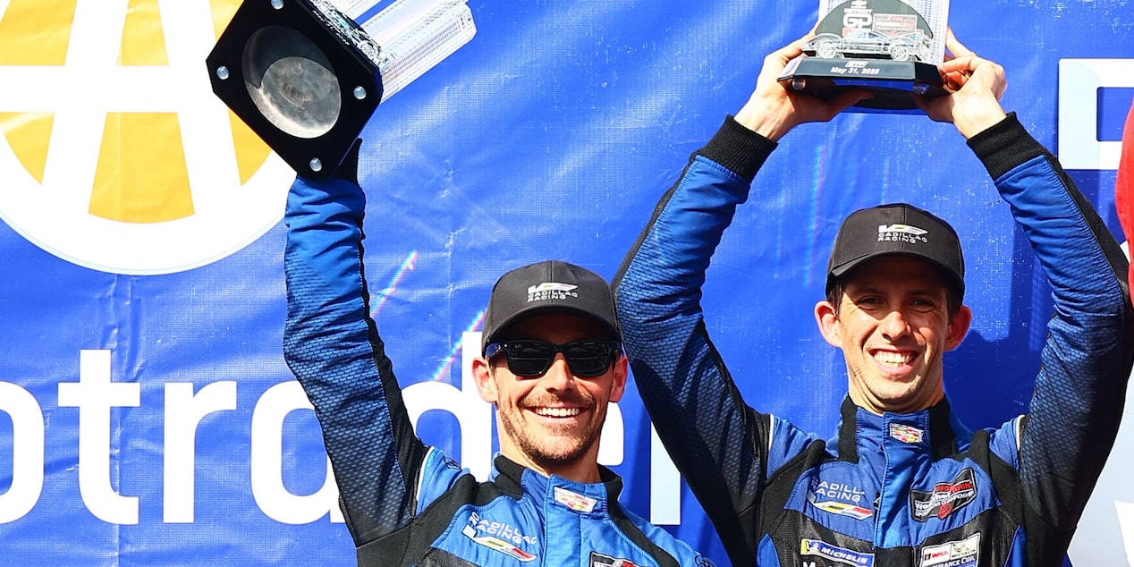 Close-up of the Cadillac Racing Team Members and Drivers Smiling and Talking on the Track