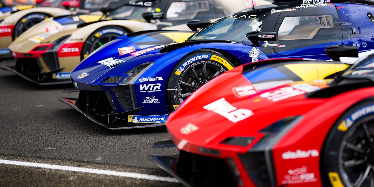 Close-Up of the Front of the V-Series Race Cars Parked and Lined Up Next to Each Other