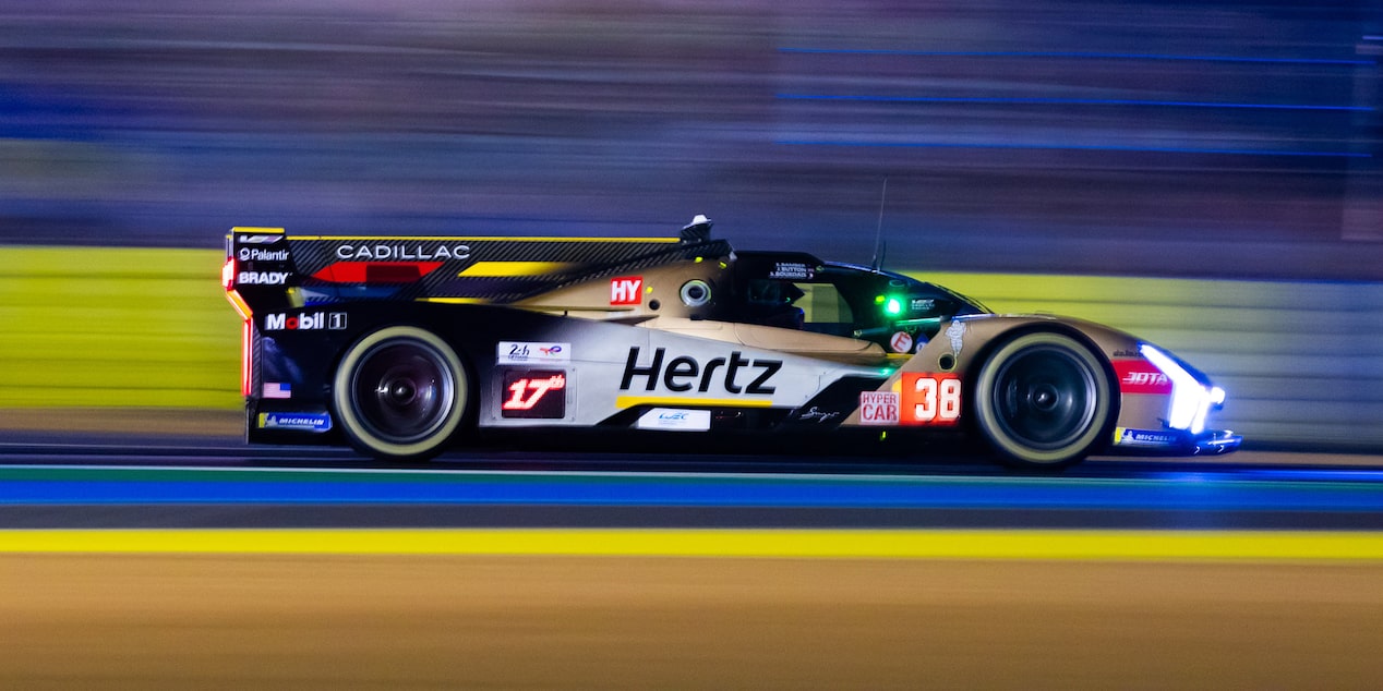 Side View of the Gold Cadillac V-Series.R Race Car Speeding Down the Track