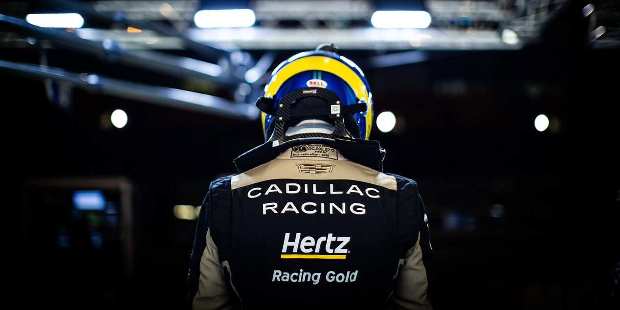 The Back of a Cadillac Race Car Driver with a Helmet On