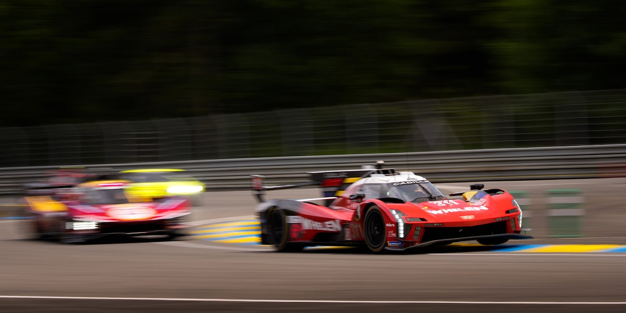 Three-Quarters View of the Red Cadillac V-Series.R Race Car Speeding Around the Curve of a Track