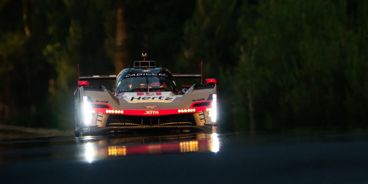 Front View of the Red Cadillac V-Series.R Driving at Night with the Headlights On