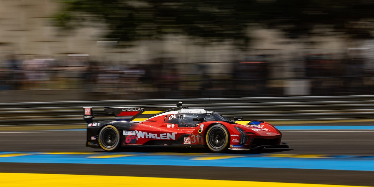 Side View of the Red Cadillac V-Series.R Race Car Speeding on the Track