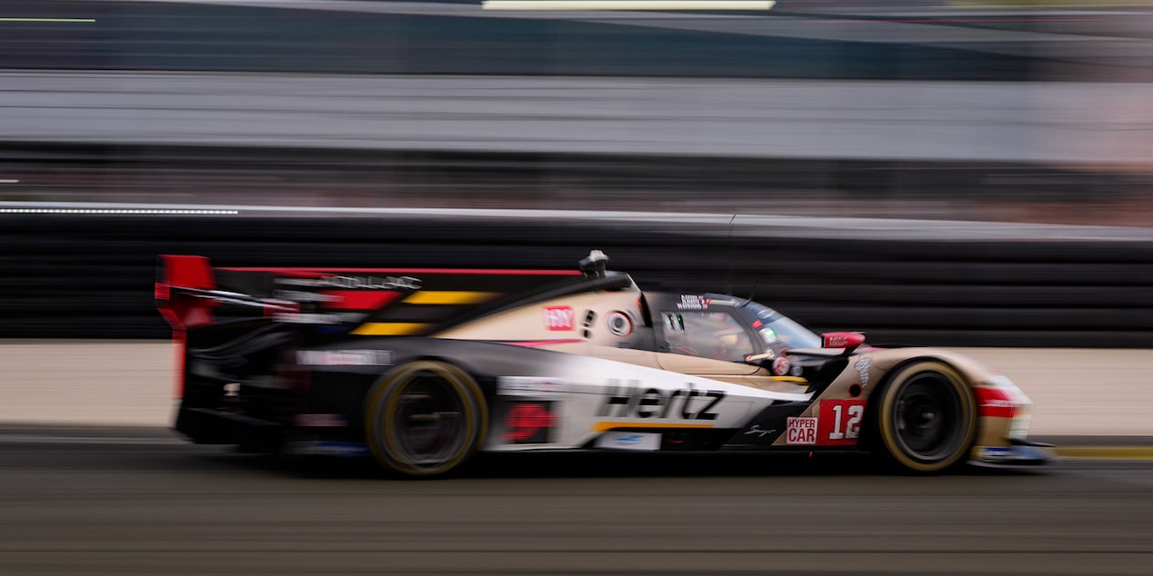 Side View of the Gold Cadillac V-Series.R Race Car Speeding Down the Track