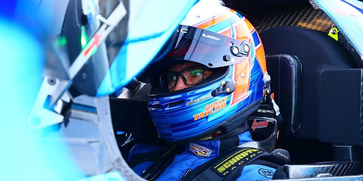 The Back of a Cadillac Race Car Driver with a Helmet On