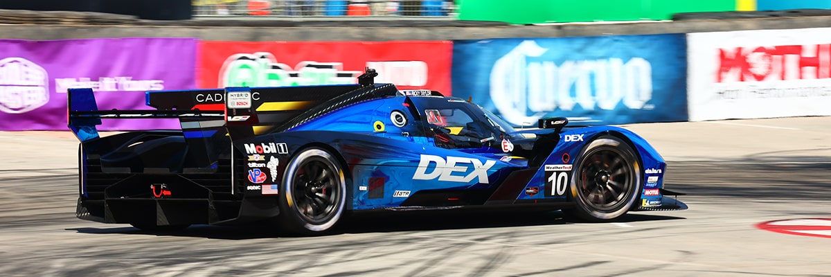 Side View of the Blue Cadillac V-Series.R Race Car Driving on the Track