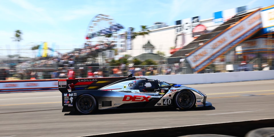 Side View of the Silver Cadillac V-Series.R Race Car Speeding on the Race Track
