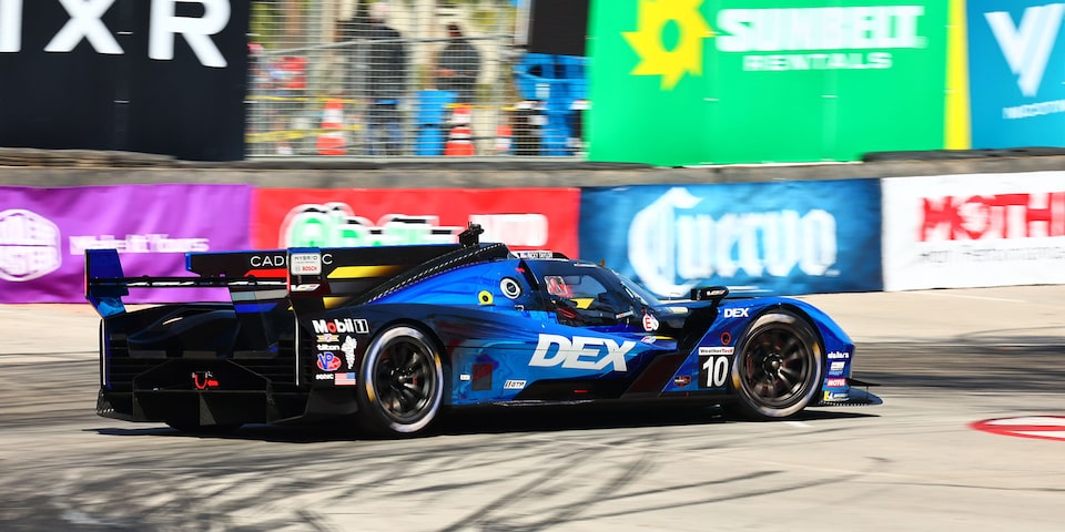 Side View of the Blue Cadillac V-Series.R Race Car Driving on the Track